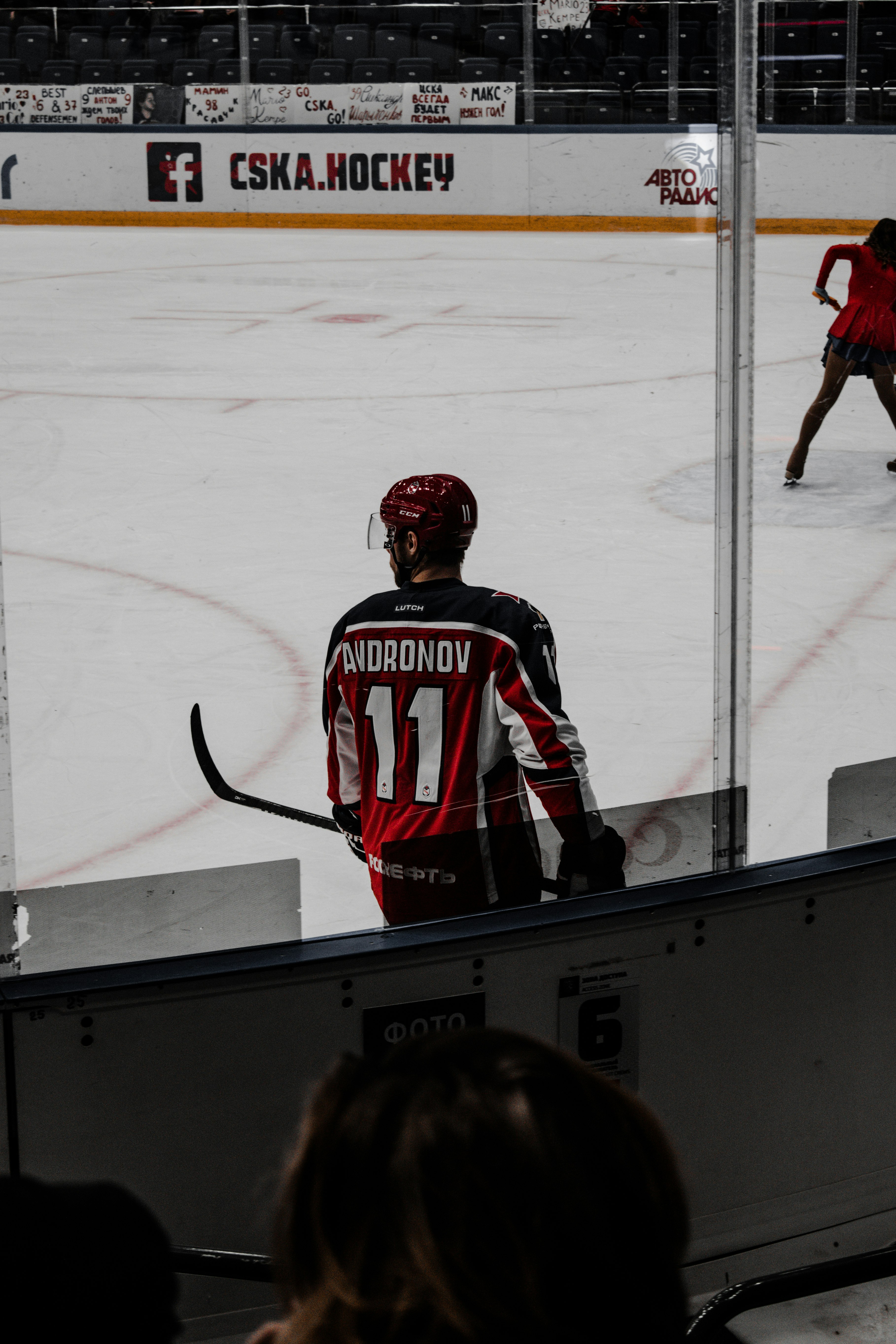 man in red and white jersey shirt wearing helmet